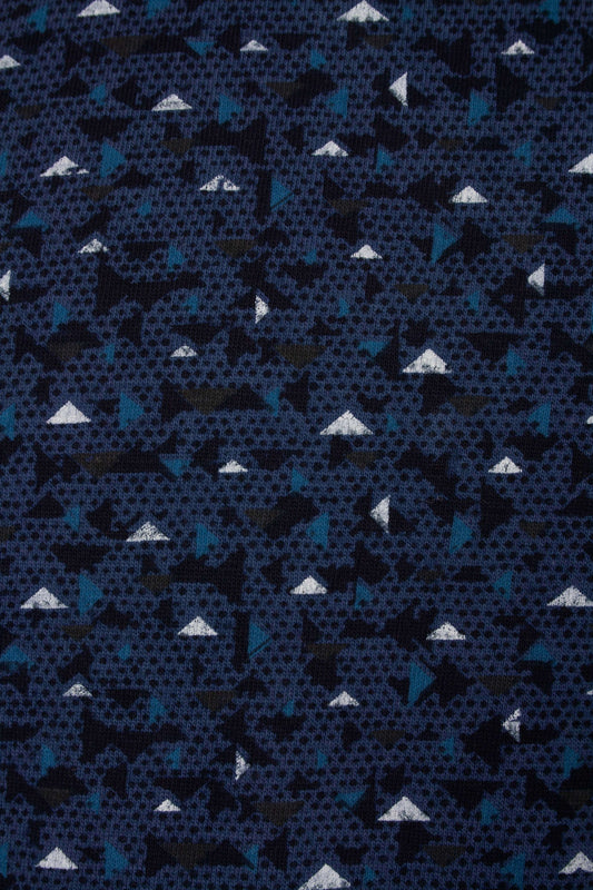 Blauwe katoenen stof met geometrisch patroon van witte driehoeken en donkere vlakken voor een peren pyjama