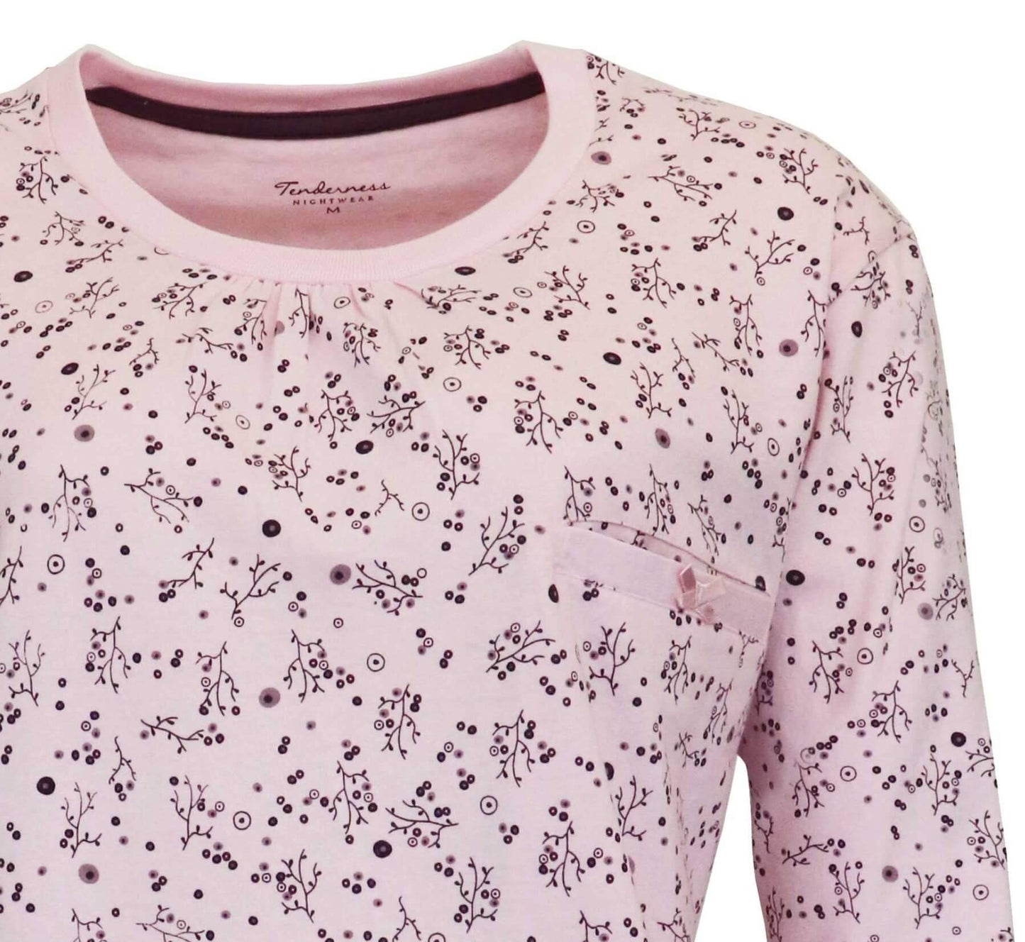 Lichtroze pyjama met ronde hals, versierd met kleine donkere bloemen enotieven en stippen op de stzachte katoenen stof.