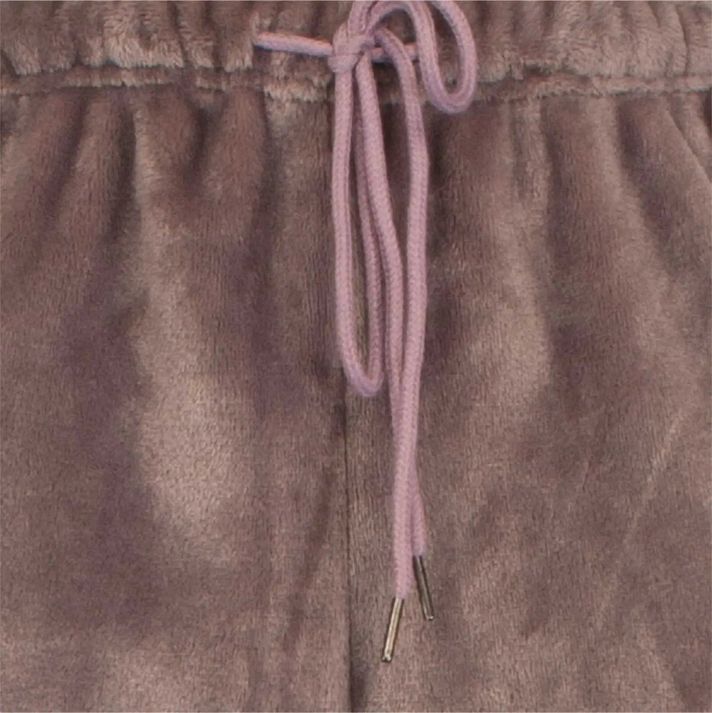 Close-up van bruine fleece stof met roze koord, detail van een huispak met panterprint