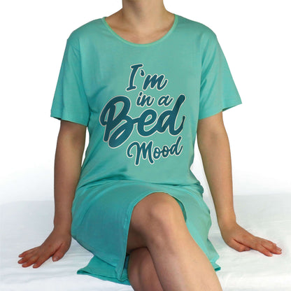 Aqua nachthemd met 'I'm in a Bed Mood' opdruk, gedragen door een zittende persoon op een wit oppervlak